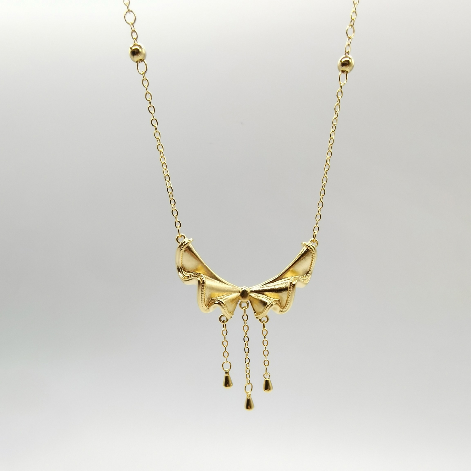 Alluvial gold vacuum electroplating 24K gold bow tassel necklace